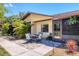 Inviting covered patio with outdoor seating surrounded by tropical landscaping, perfect for relaxing at 4169 66Th Street W Cir # 4169, Bradenton, FL 34209