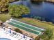 Aerial view of shuffleboard court and pool with blue chairs in the backyard at 4169 66Th Street W Cir # 4169, Bradenton, FL 34209