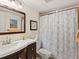 Well-lit bathroom featuring vanity with framed mirror and floral shower curtain at 4355 Longmeadow # 23, Sarasota, FL 34235