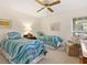 Bright bedroom with two twin beds, side table, and sunny window at 4355 Longmeadow # 23, Sarasota, FL 34235