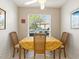 Cozy dining area featuring a table for four, bright window, and warm, inviting decor at 4355 Longmeadow # 23, Sarasota, FL 34235