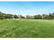 Wide view of the golf course highlighting trees and sand traps on a sunny day at 4355 Longmeadow # 23, Sarasota, FL 34235