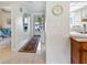 Well-lit hallway with tiled flooring that leads to the bedrooms at 4355 Longmeadow # 23, Sarasota, FL 34235