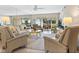 Bright living room featuring comfortable seating and a view of lush landscaping at 4355 Longmeadow # 23, Sarasota, FL 34235