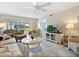 Comfortable living room with cozy seating and a screened-in lanai beyond at 4355 Longmeadow # 23, Sarasota, FL 34235