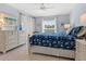 Serene main bedroom with a plush floral bed, lots of light, dresser and calm, cool paint at 4355 Longmeadow # 23, Sarasota, FL 34235