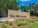 Stone entrance sign for 'The Meadows' community with manicured landscaping at 4355 Longmeadow # 23, Sarasota, FL 34235