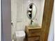 Stylish bathroom featuring a modern vanity, toilet, and a bright mirror at 4408 125Th W St, Cortez, FL 34215