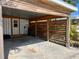 The carport features wood beam construction, concrete flooring and a stylish wooden privacy screen at 4408 125Th W St, Cortez, FL 34215