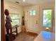 Welcoming entryway featuring a decorative door, rustic decor, 'Home Sweet Home' sign, and ample natural light at 4408 125Th W St, Cortez, FL 34215