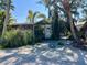 Charming home nestled among mature landscaping, lush trees, and a sandy front yard at 4408 125Th W St, Cortez, FL 34215