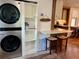 Cozy laundry room featuring a stackable washer and dryer with counter seating and bar stools into the kitchen at 4408 125Th W St, Cortez, FL 34215