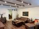 Inviting living room with hardwood floors, wood beam ceiling, comfortable leather seating, and stylish rustic decor at 4408 125Th W St, Cortez, FL 34215