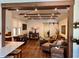 Spacious living area with hardwood floors, barn door, exposed beam ceiling, and open access to the dining and kitchen areas at 4408 125Th W St, Cortez, FL 34215
