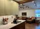 Open living space with hardwood floors, modern appliances, exposed beam ceiling, and comfortable seating area at 4408 125Th W St, Cortez, FL 34215