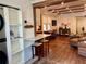 Open-concept living space with hardwood floors, bar seating, modern appliances, and a comfortable seating area at 4408 125Th W St, Cortez, FL 34215