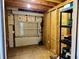 This unfinished storage area features wood walls, a window, and exposed insulation, ready for organization at 4408 125Th W St, Cortez, FL 34215