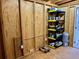 Unfinished storage room with wood paneling, shelving, and an electric outlet for convenience at 4408 125Th W St, Cortez, FL 34215