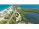 Aerial view showcases a waterfront condo, boat docks, and proximity to the beach at 4500 Gulf Of Mexico Dr # Ph4, Longboat Key, FL 34228