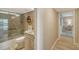 Bathroom with a glass shower, tiled showerhead, and a hallway in the background at 4500 Gulf Of Mexico Dr # Ph4, Longboat Key, FL 34228