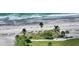 Aerial view of a beach with turquoise water and palm trees on a sunny day at 4500 Gulf Of Mexico Dr # Ph4, Longboat Key, FL 34228