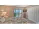 Comfortable bedroom with a plush bed, ensuite bath, and sliding glass doors leading to a balcony at 4500 Gulf Of Mexico Dr # Ph4, Longboat Key, FL 34228