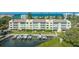 Multi-story building near a marina with multiple boats docked on the water at 4500 Gulf Of Mexico Dr # Ph4, Longboat Key, FL 34228