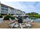 Community outdoor dock area with seating and boat parking at water's edge at 4500 Gulf Of Mexico Dr # Ph4, Longboat Key, FL 34228