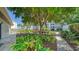 Tranquil garden setting with walkways, lush greenery, and a bench offering a peaceful outdoor escape at 4500 Gulf Of Mexico Dr # Ph4, Longboat Key, FL 34228