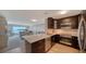 Well-equipped kitchen features dark cabinetry and granite countertops with a view of living area at 4500 Gulf Of Mexico Dr # Ph4, Longboat Key, FL 34228