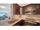 Contemporary kitchen featuring granite counters, stainless appliances, and sleek, dark wood cabinetry at 4500 Gulf Of Mexico Dr # Ph4, Longboat Key, FL 34228