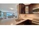 Contemporary kitchen featuring granite counters, stainless appliances, and sleek, dark wood cabinetry at 4500 Gulf Of Mexico Dr # Ph4, Longboat Key, FL 34228
