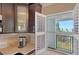 Contemporary kitchen featuring granite counters, stainless appliances, and a view of the balcony at 4500 Gulf Of Mexico Dr # Ph4, Longboat Key, FL 34228