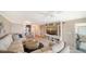Open living room area with sectional sofa, ceiling fan, and waterfront views at 4500 Gulf Of Mexico Dr # Ph4, Longboat Key, FL 34228