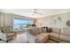 Living room with expansive windows offering stunning waterfront views and modern decor at 4500 Gulf Of Mexico Dr # Ph4, Longboat Key, FL 34228