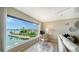 Living room with expansive windows offering stunning waterfront views and natural light at 4500 Gulf Of Mexico Dr # Ph4, Longboat Key, FL 34228