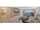 Bright living room with large windows, comfortable seating, and entertainment center at 4500 Gulf Of Mexico Dr # Ph4, Longboat Key, FL 34228