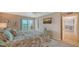 Comfortable main bedroom with a plush bed, ensuite bath, and sliding glass doors leading to a balcony at 4500 Gulf Of Mexico Dr # Ph4, Longboat Key, FL 34228