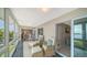 Bright sunroom furnished with seating, large windows, and access to the living area at 4500 Gulf Of Mexico Dr # Ph4, Longboat Key, FL 34228