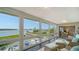 Relaxing sunroom with wicker furniture and waterfront views through large windows at 4500 Gulf Of Mexico Dr # Ph4, Longboat Key, FL 34228
