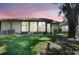 Charming backyard with lush green lawn and privacy provided by mature trees at 4722 Oak Hill Ln # 44, Sarasota, FL 34232