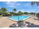 Enjoy the sunshine by the community pool with lounge chairs, umbrellas, and lush tropical landscaping at 4722 Oak Hill Ln # 44, Sarasota, FL 34232