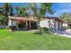 Charming home with well-manicured lawn, blossoming tree, and attached two-car garage at 4722 Oak Hill Ln # 44, Sarasota, FL 34232