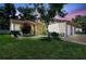 Charming home with well-manicured lawn, blossoming tree, and attached two-car garage at 4722 Oak Hill Ln # 44, Sarasota, FL 34232