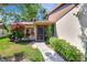 Home exterior featuring a screened entry way and blooming landscaping at 4722 Oak Hill Ln # 44, Sarasota, FL 34232