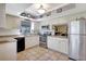 Traditional kitchen featuring white cabinets, stainless steel appliances, and tiled flooring at 4722 Oak Hill Ln # 44, Sarasota, FL 34232