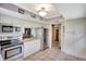 Well-lit kitchen showcasing stainless steel appliances, white cabinetry, and easy access to other rooms at 4722 Oak Hill Ln # 44, Sarasota, FL 34232