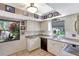 Charming kitchen features white cabinets, modern appliances, and a bright window overlooking lush greenery at 4722 Oak Hill Ln # 44, Sarasota, FL 34232
