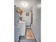 Laundry area featuring a washer, dryer, shelving, and water heater at 4722 Oak Hill Ln # 44, Sarasota, FL 34232