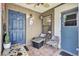 Cozy screened porch with seating, tile flooring, and dual entry doors at 4722 Oak Hill Ln # 44, Sarasota, FL 34232